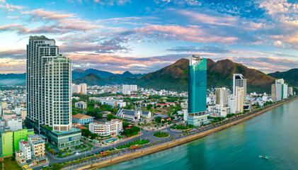 Fototapeta na wymiar The coastal city of Nha Trang seen from above in the afternoon with its beautiful city and clean sandy beach attracts tourists to visit in Nha Trang, Vietnam