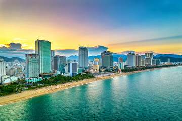 Naklejka premium The coastal city of Nha Trang seen from above in the afternoon with its beautiful city and clean sandy beach attracts tourists to visit in Nha Trang, Vietnam