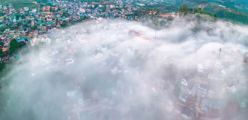 Aerial view of the town in the early morning mist is beautiful in the highlands of Da Lat, Vietnam