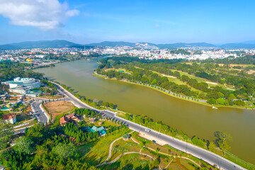 Aerial view of Da Lat city beautiful tourism destination in central highlands Vietnam. Urban development texture, green parks and city lake.