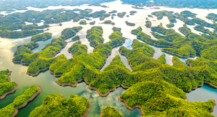 Landscape Ta Dung lake seen from above in the morning with small islands many green trees in succession to create a magnificent beauty. This is the largest hydroelectric lake in Dak Nong, Vietnam