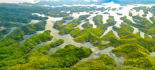 Landscape Ta Dung lake seen from above in the morning with small islands many green trees in...