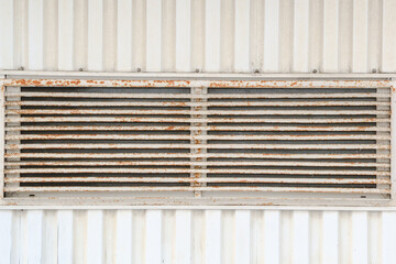 Old, rusty, with peeling paint, ventilation window grille on a sheathing wall, background image, texture