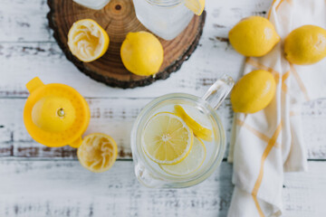 Jar glass of lemonade drink with yellow lemons or lime on a white background in Latin America