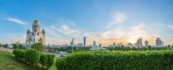 Fototapeta premium Panorama of spring or summer Yekaterinburg and Temple on Blood in orange sunset light. Yekaterinburg, Russia
