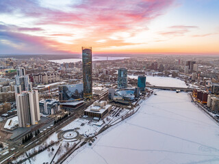 Fototapeta na wymiar Yekaterinburg aerial panoramic view in Winter at beautiful pink and orange sunset. Yekaterinburg city and pond in winter.