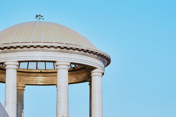 Granite columns of the rotunda support a dome with a transparent roof. Sun glare on the surface of...