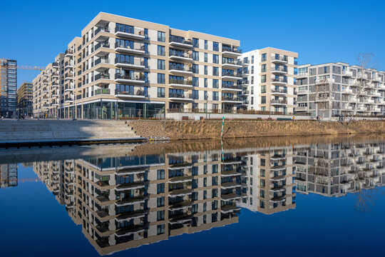 Modern apartment buildings in Berlin with a perfect reflection in a small canal
