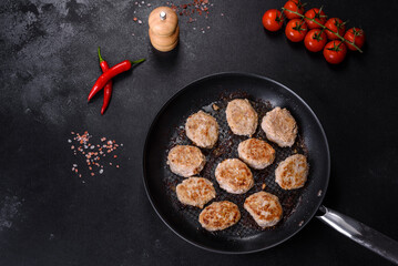 Delicious fresh fried minced meat patties on a dark concrete background