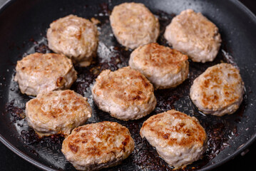 Delicious fresh fried minced meat patties on a dark concrete background