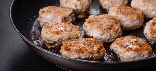 Delicious fresh fried minced meat patties on a dark concrete background