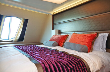 Oceanview outside exterior bedroom stateroom cabin suite in clean modern interior design onboard...