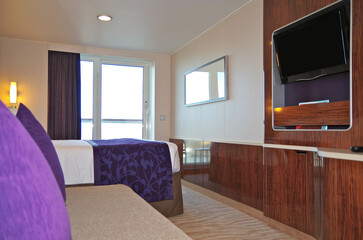 Balcony veranda bedroom stateroom cabin suite in clean modern interior design onboard luxury...