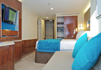 Balcony veranda bedroom stateroom cabin suite in clean modern interior design onboard luxury...
