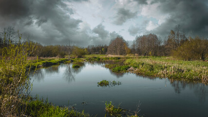 Polish landscape with a small river in the background at sunset.