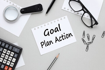torn sheet of paper on gray background text goal plan action