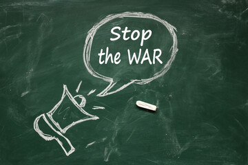 horn drawn in chalk. inscription Stop the war