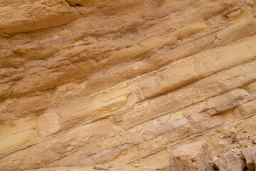 rock formation with sand and lava rock in desert with grain and out of focus up close