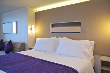 Bedroom of penthouse stateroom cabin suite in clean modern interior design onboard luxury...