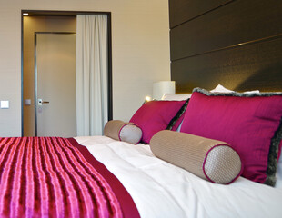 Bedroom of penthouse stateroom cabin suite in clean modern interior design onboard luxury...