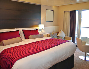 Bedroom of penthouse stateroom cabin suite in clean modern interior design onboard luxury...