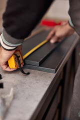 Handyman making kitchen wall cabinets in the apartment.
