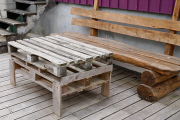 Fototapeta na wymiar recycled wood table bench made from old wooden storage pallet diy on home garden terrace