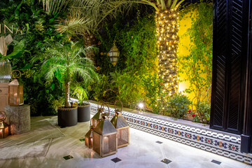 Copper lanterns with candles at night with grain and out of focus