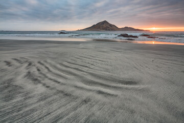 Fototapeta na wymiar Seascape with beach, ocean and island at sunset, Pan de Azucar National Park in the north of Chile