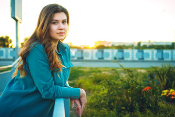 Beautiful young woman with long hair outdoor. Time before sunset. Spring mood.