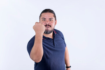 A burly and stocky man warns someone with his fist to keep their distance or not to piss him off....