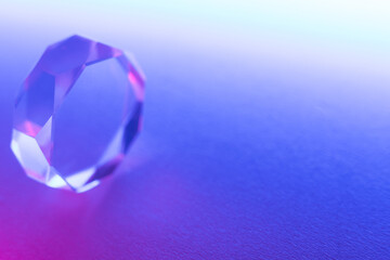 Optical glass objects with multi-colored lighting. Neon background with geometric shapes, soft selective focus, copy space.