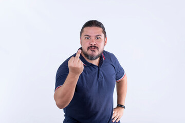 A ticked off man in his 30s defiantly gives the middle finger. Being headstrong and angry against...
