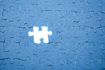 Puzzle piece missing with white light, concept of completing a task, reaching a goal, finishing a...
