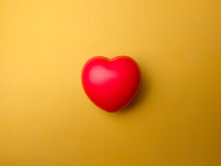 Top view red heart shape on yellow background. Can use for heart check up or love concept