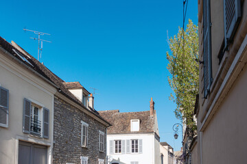 Fototapeta na wymiar Milly-la-Foret, FRANCE - April 16, 2022: Antique building view in Milly-la-Foret, France