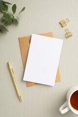 Business concept. Top view vertical photo of paper sheet craft paper envelope gold pen binder clips...