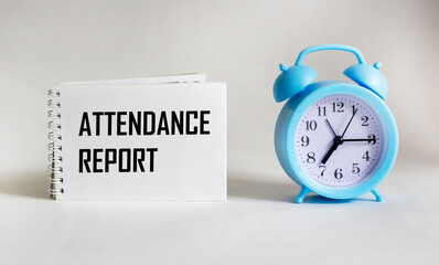 On a white background is a notebook with the text ATTENDANCE REPORT. Business concept. Banner