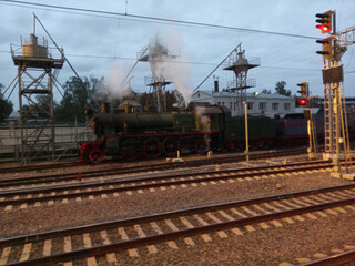 Fototapeta na wymiar steam locomotive on rails at dry morning