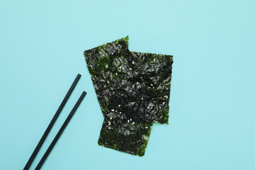 Concept of Japanese food, seaweed nori on blue background