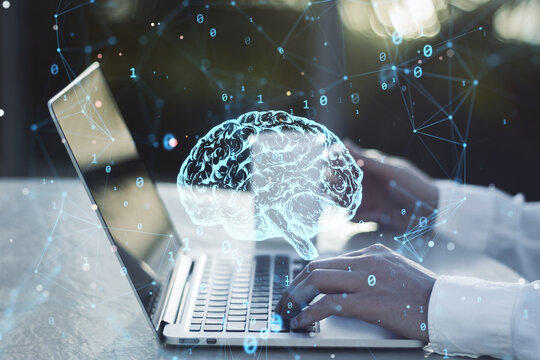 Close up of businessman hands using laptop with creative polygonal brain hologram on blurry background. Neurology and anatomy concept. Double exposure.