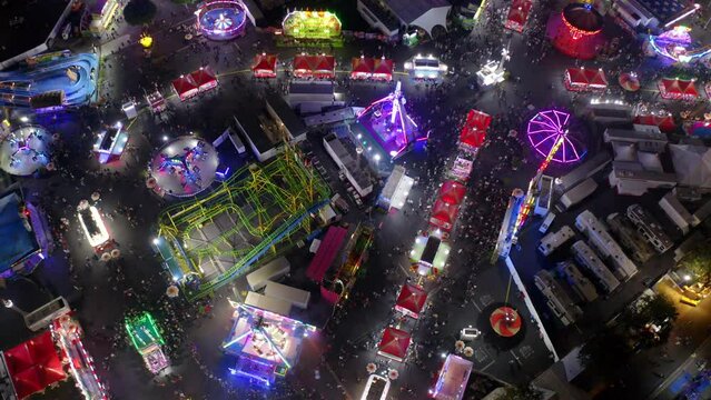 Aerial Lockdown Shot Of People Having Fun At Funfair In City At Night - Costa Mesa, California