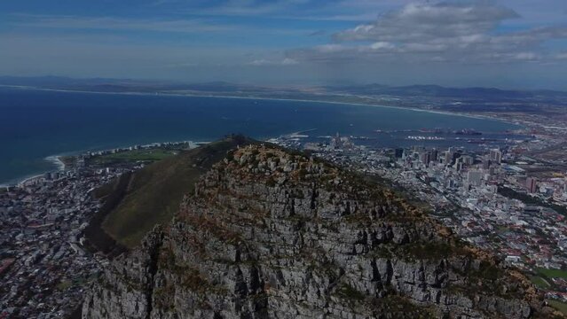 Drone shot of Lions Head in Cape Town - drone is circling around the top of Lions Head, facing Signal Hill and Sea Point. Snippet could ideally be used for travel related videos or Cape Town movies.