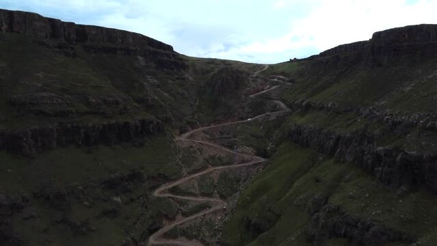 Drone shot of Drakensberg in South Africa - drone is flying up Sani Pass into Lesotho. Snippet could ideally be used for travel related videos or hiking movies.