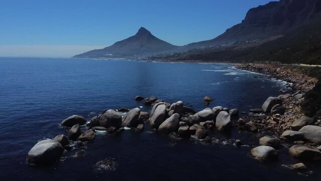 Drone shot of Cosy bay in Cape Town - drone is flying over the water facing Lions Head in the back. Snippet could ideally be used for travel related videos or Cape Town movies.