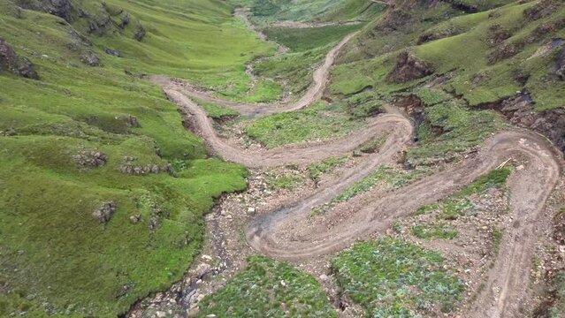Drone shot of Drakensberg in South Africa - drone is flying down Sani Pass and revealing the mountains. Snippet could ideally be used for travel related videos or hiking movies.