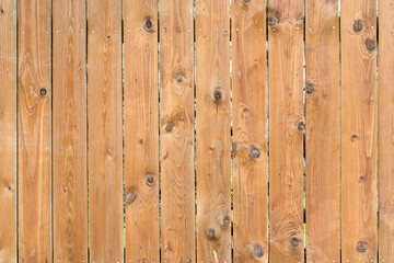 Fototapeta premium Vintage fence of old wooden boards. Texture of an aging wooden surface. Beautiful wooden background.