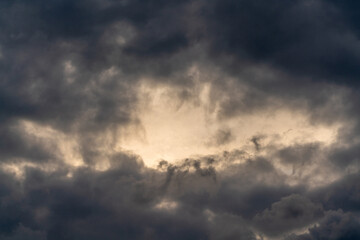 Dark gloomy clouds on a stormy sky. Natural atmospheric background.