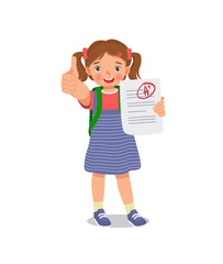 Happy little schoolgirl holding exam paper with good mark A plus grade in test result showing thumb up gesture