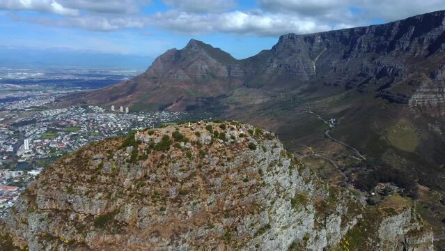 Drone shot of Lions Head in Cape Town - it is circling around the top of Lions Head, facing Table Mountain and city center. Snippet could ideally be used for travel related videos or Cape Town movies.